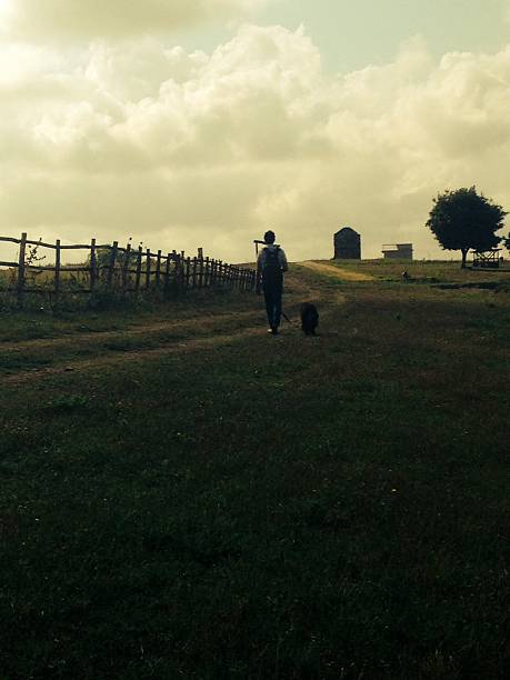 istock man with dog on country road 516527711