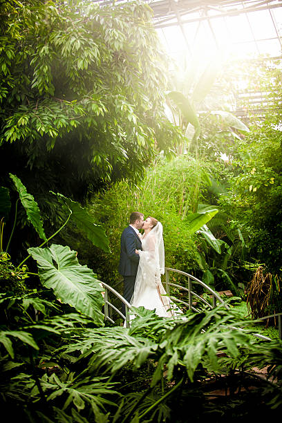 istock Married couple kissing on sunny day at rain forest 516531175