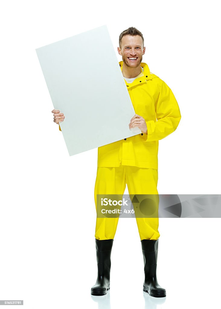 Cheerful man in raincoat & holding placard Cheerful man in raincoat & holding placardhttp://www.twodozendesign.info/i/1.png 30-34 Years Stock Photo