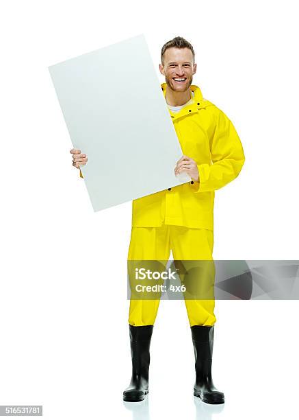 Cheerful Man In Raincoat Holding Placard Stock Photo - Download Image Now - 30-34 Years, 30-39 Years, Adult