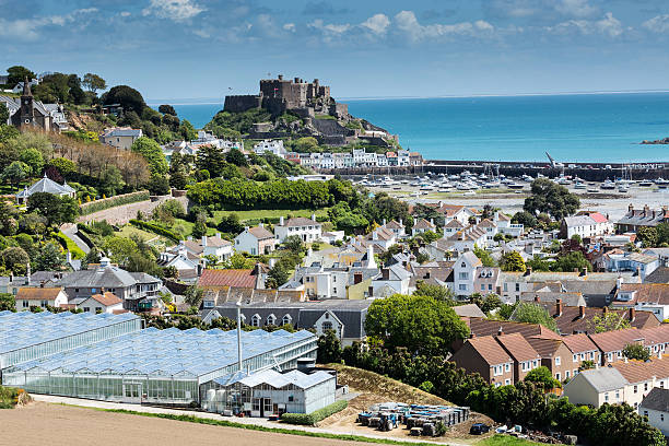 Gorey, Jersey, UK View to Mont Orgueil Castle with harbour in Gorey, Jersey, UKView to Mont Orgueil Castle with harbour in Gorey, Jersey, UK channel islands england stock pictures, royalty-free photos & images