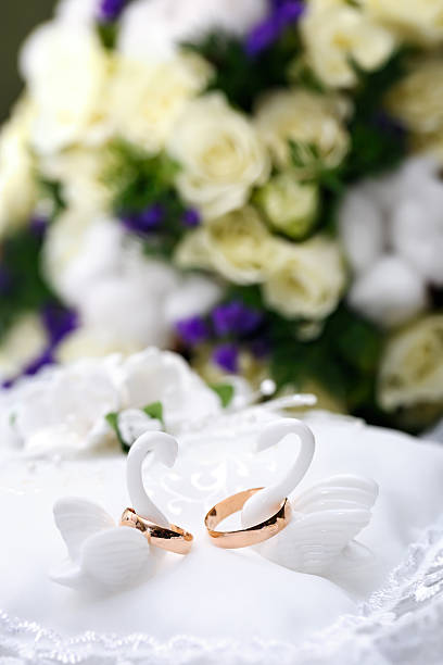 istock Wedding gold rings bride and groom on decorative pillow. 516541698