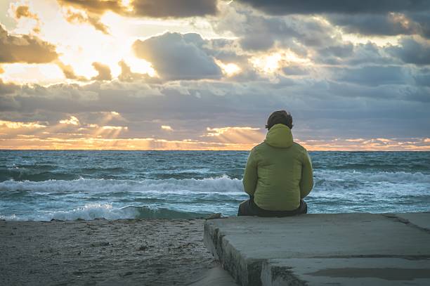 istock Man Traveler relaxing alone on beach seaside 516542700