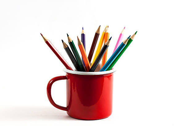 istock Stack of colored pencils in a glass on white background 516542740