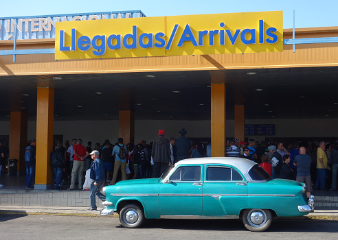 Havana, Cuba.  February 13, 2016.  An old car is parked in front of the Jose Marti Airport arrival building.