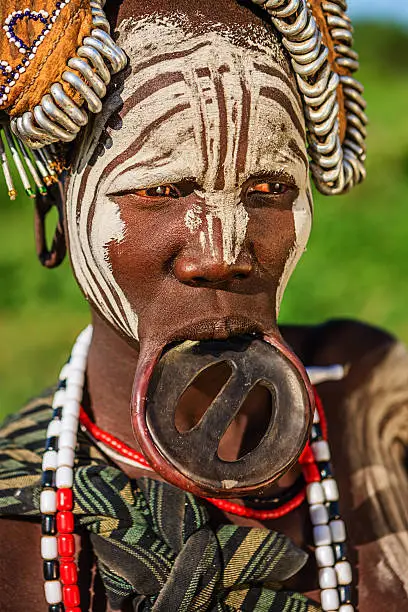 Woman from Mursi tribe with face paint. Mursi tribe are probably the last groups in Africa amongst whom it is still the norm for women to wear large pottery or wooden discs or ‘plates’ in their lower lips.http://bem.2be.pl/IS/ethiopia_380.jpg