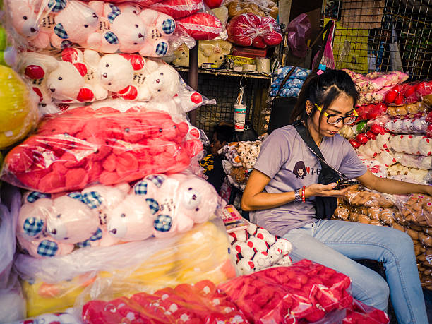Bangkok, Thailand - February 12, 2016: Female vendor selling stuffed toys at the Sampeng street market in Chinatown Bangkok Thailand.  