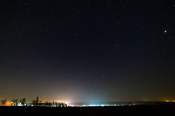 istock Starry sky above the illuminated city. 516544728