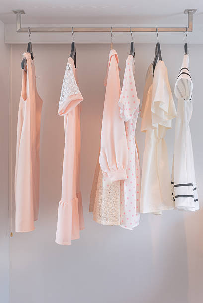 istock white closet with dress hanging 516544934