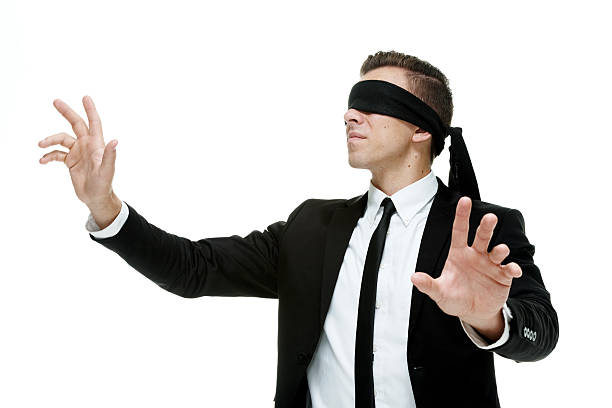 istock Businessman with blindfold on searching 516546011