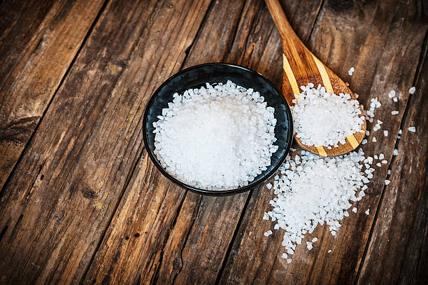 istock Sea salt in bowl on wooden background 516546142