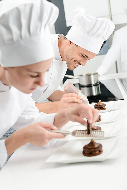 istock pastry cook professional team in restaurant kitchen preparing chocolate dessert 516546302