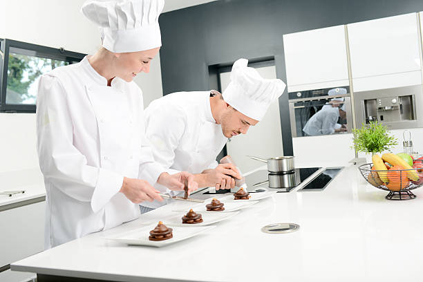 istock pastry cook professional team in restaurant kitchen preparing chocolate dessert 516546664