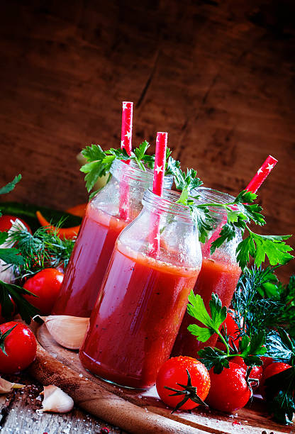 istock Spicy tomato juice in small bottles with straws, cherry tomatoe 516546864