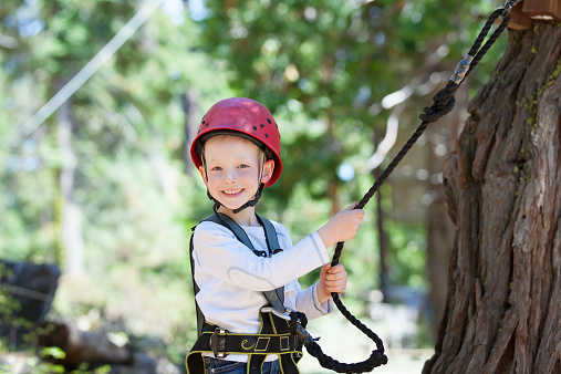 happy kid climbing at adventure park