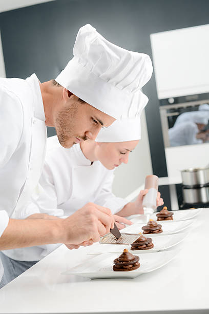 istock pastry cook professional team in restaurant kitchen preparing chocolate dessert 516547378