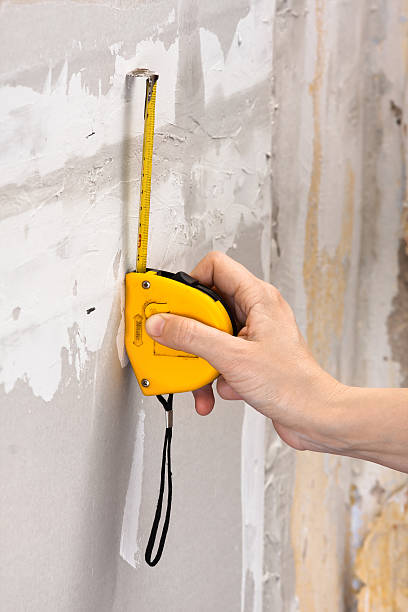 istock measuring wall with tape measure 516548056