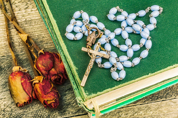 istock Rosary, bible and dried roses  on the table 516548828