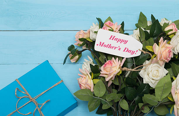 istock Mothers day card and  roses on blue background with gift 516549138
