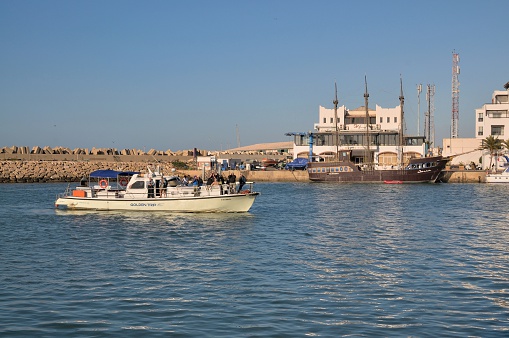Agadir, Morocco - February 16, 2016: A large group of birding enthusiasts prepare to depart the marina in Agadir, Morocco on a pelagic trip to the North Atlantic Ocean off the western coast of Morocco on a tour ship. They will be at sea for most of the day searching for new species to put on their world list of birds