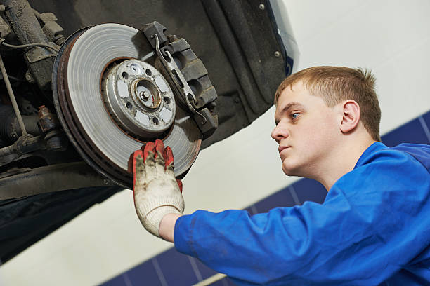 istock auto mechanic at car brake shoes eximining 516549509