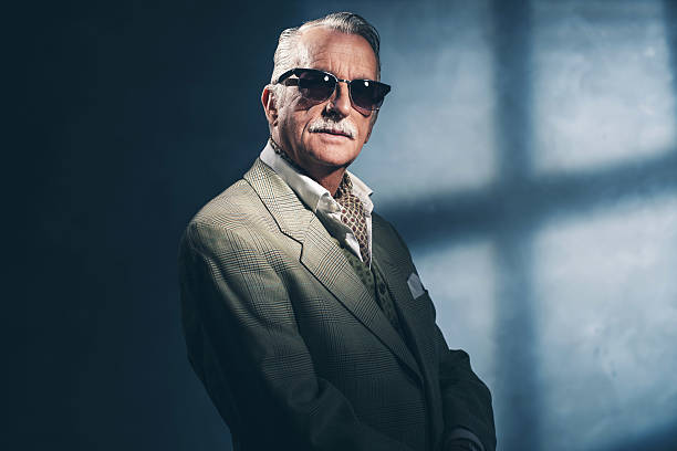 istock Retro 1940 senior businessman wearing sunglasses. Studio shot. 516549742