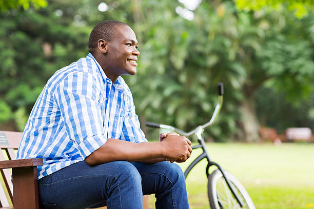 istock young african man sitting outdoors 516550331