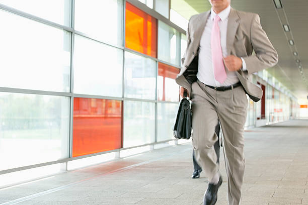 istock Midsection of businessmen rushing on railroad platform 516551281