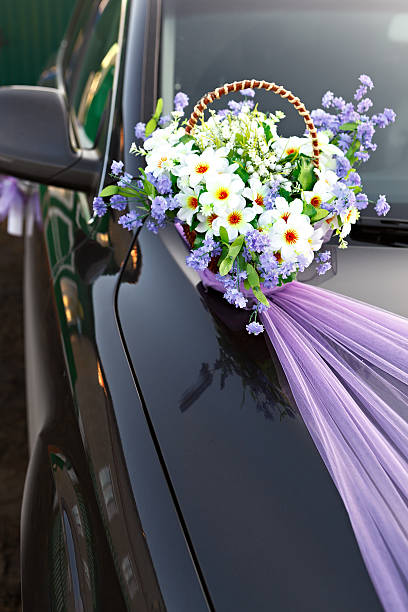 istock Decorating wedding car basket with flowers. 516551414