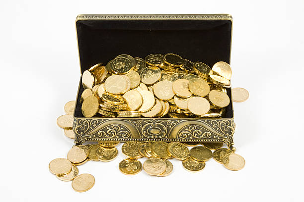 istock gold casket and gold coins on a white background 516551545