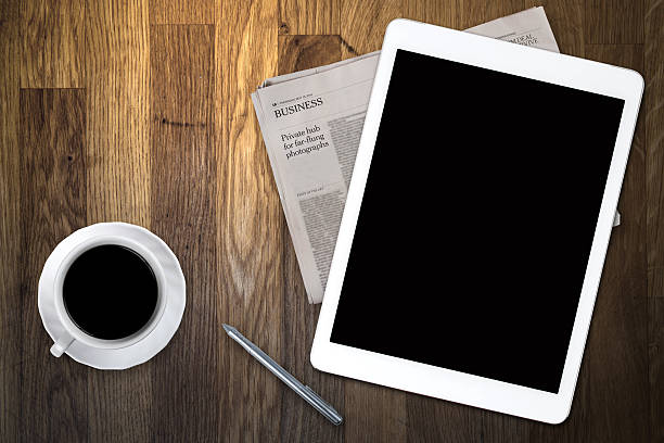 istock tablet and coffee on old wooden table 516551613