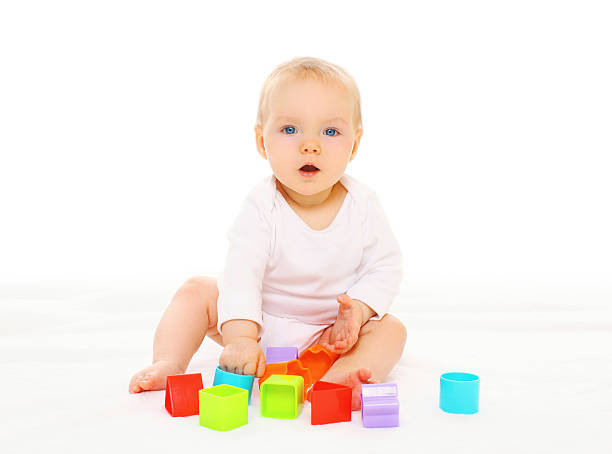 istock Baby playing with colorful toys on a white background 516552048
