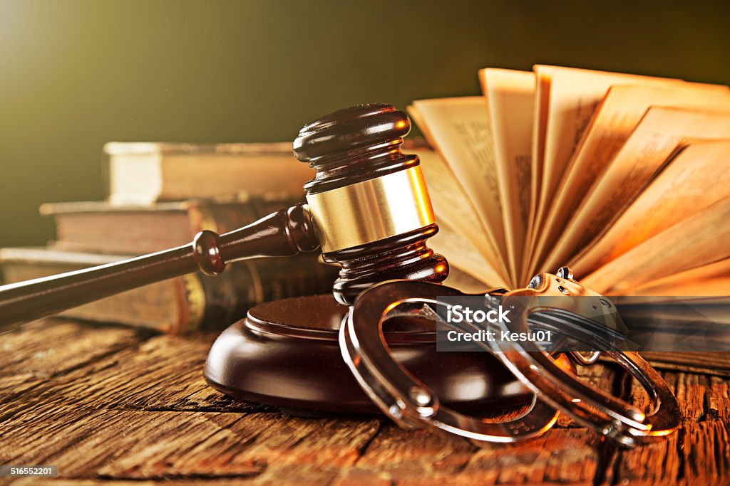 Wooden gavel and books on wooden table Wooden gavel and books on wooden table, law concept Law Stock Photo