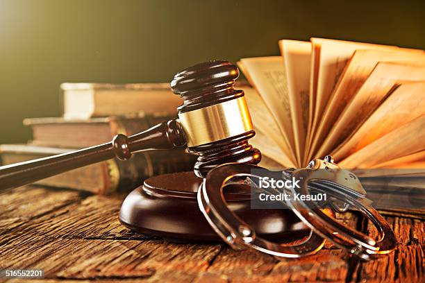 Wooden Gavel And Books On Wooden Table Stock Photo - Download Image Now - Law, Handcuffs, Auction