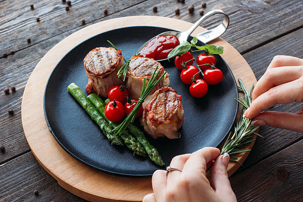 istock Food  decorating. Chef decorating a pork dish. 516552500