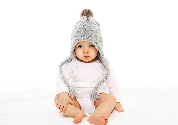 istock Baby in grey knitted hat on a white background 516552708