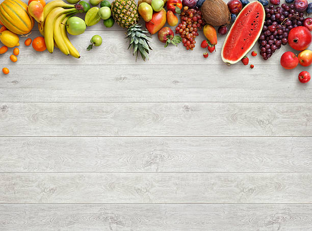 Studio photo of different fruits on white wooden table. stock photo