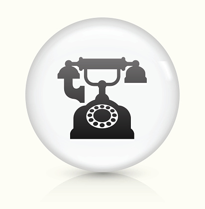 Antique Phone Icon on simple white round button. This 100% royalty free vector button is circular in shape and the icon is the primary subject of the composition. There is a slight reflection visible at the bottom.