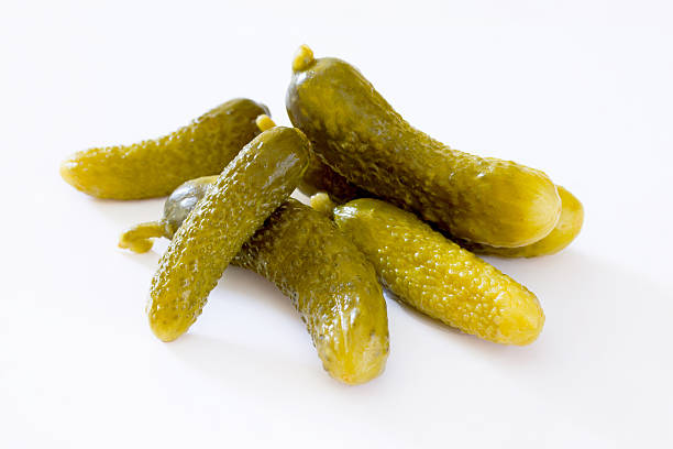istock Pickled Cucumbers gherkins on a white background 516554070