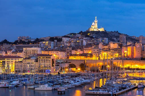 Marseille, France at night. The famous european harbour view on the Notre Dame de la Garde