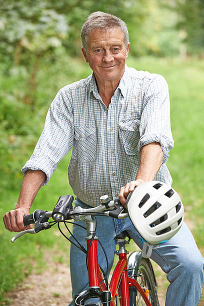 istock Senior Man Enjoying Cycle Ride In The Countryside 516586345