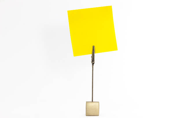 istock Paperclip holds yellow sticky note 516586737