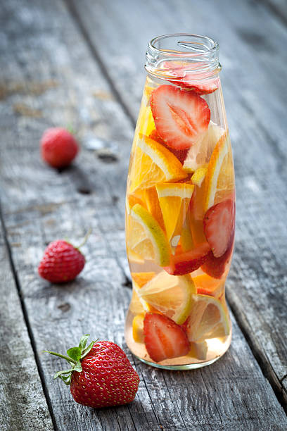 istock Fresh fruit detox water in bottle on wooden table 516586971