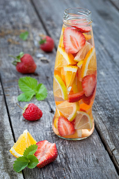 istock Fresh fruit detox water in bottle on wooden table 516586973