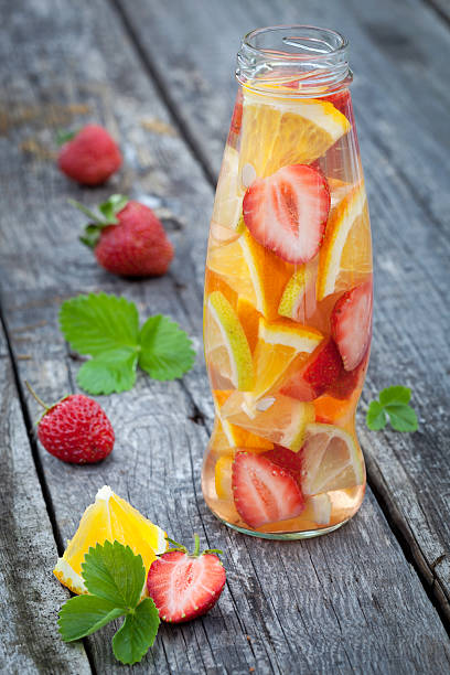 istock Fresh fruit detox water in bottle on wooden table 516586975