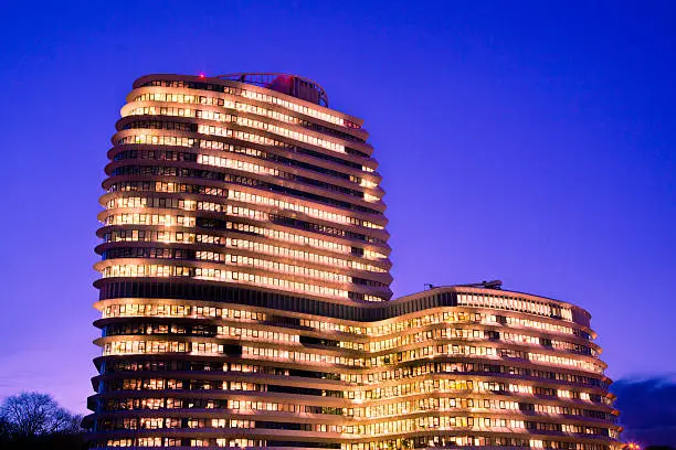 Long Working Hours in a Tall Modern Office Building with Lights during the Blue Hour
