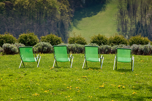 Green deck chairs with the view on the meadow
