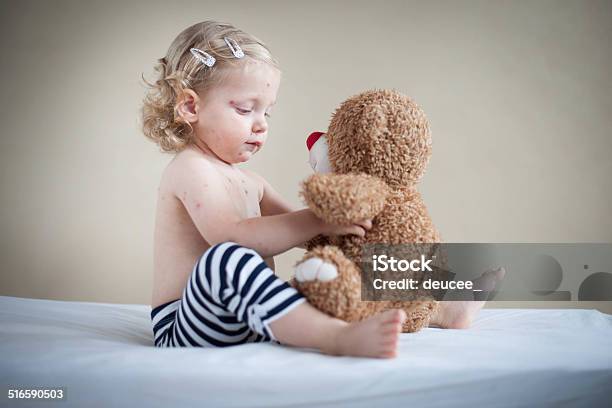 Sick Girl Is Sitting On The Bed With Teddybear Stock Photo - Download Image Now - 18-23 Months, 2-3 Years, Animal
