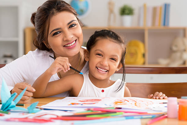 Painting with gouache Portrait of happy mother and daughter painting with gouache young children pictures stock pictures, royalty-free photos & images