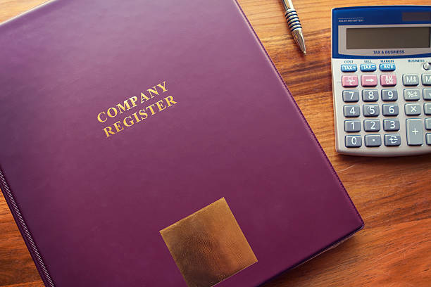istock Company Register documents with pen and calculator 516591593